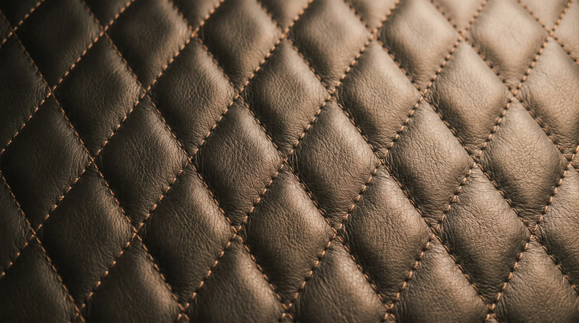 Sharp tailoring against stitched leather inside a chauffeured sedan